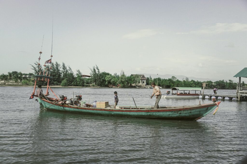 a man standing on top of a boat in the water